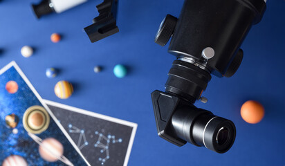 Detail of eyepiece mounted on a telescope and blue background