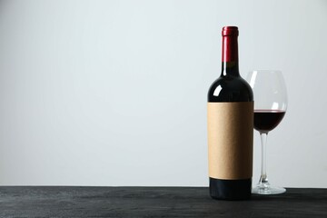 Red wine bottle with wineglass on the bottle