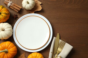 Rustic holiday table setup. Top view with plates, cutlery and autumn decorations. Empty space for your text 
