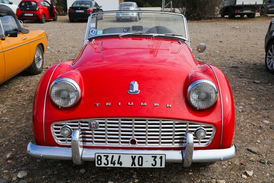 CADAQUES, SPAIN - OCTOBER 5, 2021: Vintage Triumph TR2 red roadster sports car parked in Spain.