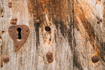 Rustic wooden door with a heart-shaped keyhole