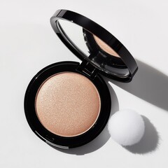 Cosmetic compact with shimmering powder displayed on a clean surface
