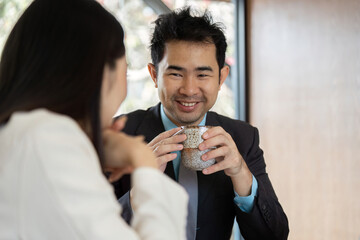 Business professionals enjoying coffee during a meeting, fostering a relaxed atmosphere.