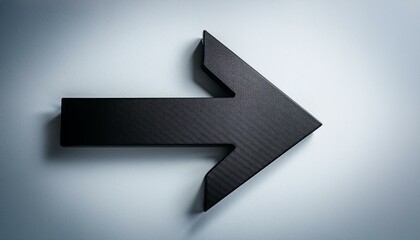 Obraz premium Black arrow pointing in a direction, set against a clean background, symbolizing navigation and direction.