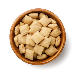 Crispy corn pads in a wooden plate close-up on a white background. Top view