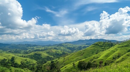 Fototapeta premium A vibrant landscape featuring rolling green hills under a bright blue sky.