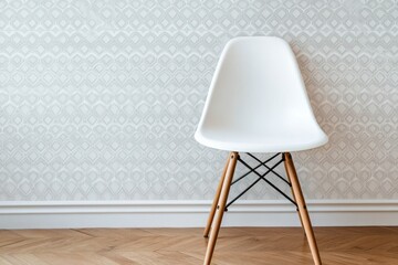White plastic chair against patterned wallpaper.