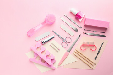 Set of pedicure tools on pink background, flat lay