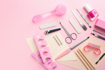 Set of pedicure tools on pink background, flat lay