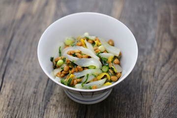 Ika-natto is a Japanese dish made by mixing squid sashimi with natto (fermented soybeans) and seasonings such as green onions.