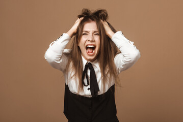 Emotional Brunette Young Woman in Shock. Portrait of Lady Grabbing Head and Tearing Hair in Desperation. Concept of Crisis, Stress, and Overwhelming Situations