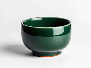 An isolated green ceramic bowl and cup, empty and clean, are simple kitchenware
