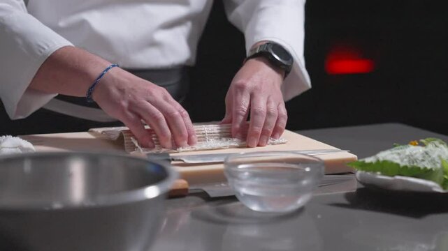 A static shot captures sushi rice being flipped, showcasing precision and technique in sushi preparation. Perfect for culinary, sushi-making, and professional kitchen content.