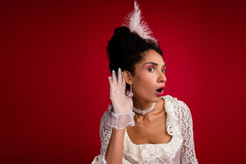 Young woman in elegant vintage attire with red background listening attentively, blending past and...