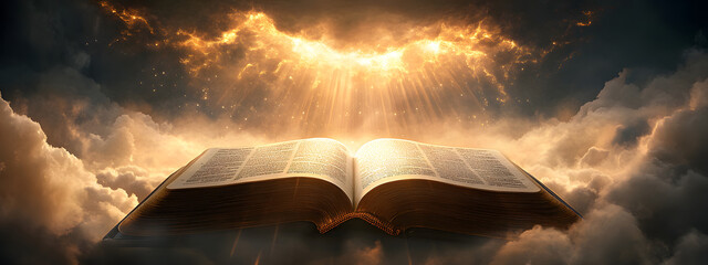An open Bible with rays of light shining down on it, the background is dark and cloudy
