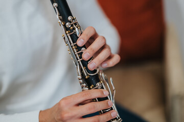 A detailed close-up of a person playing the clarinet, emphasizing the intricate design and...
