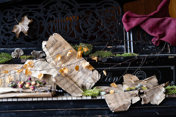 a century-old grand piano with century-old notes and dried flowers on it, with a time stamp on them