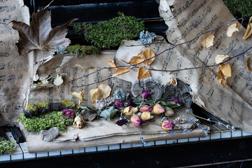 a century-old grand piano with century-old notes and dried flowers on it, with a time stamp on them