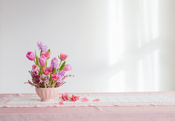 pink flowers in vase on background white wall