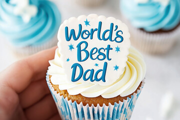 Hand holding cupcake with world's best dad topper. Sweet gift for Father's day and birthday. Concept for father's day celebration, birthday, appreciation.