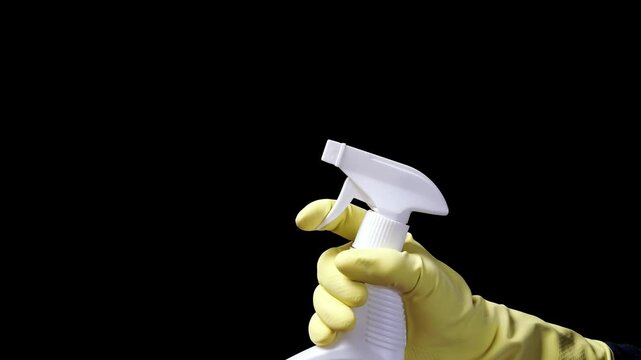 Cleaning spray bottle. Hand in protective glove holding cleaning spray bottle