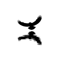 Fototapeta premium In this striking black-and-white artwork, the silhouette of an eagle in flight dominates the scene, its wings spread wide in a dramatic display of power and grace. Flying low over the water, the eagle