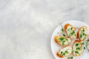 Plate of sandwiches with cream cheese and micro greens peas. Healthy food, top view