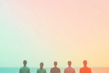 Silhouettes of five figures standing together against serene oce