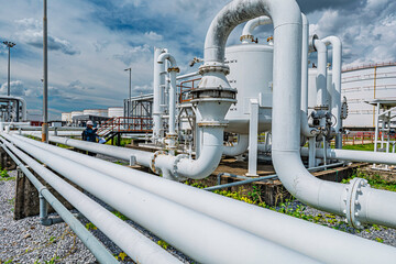 Male worker inspection at steel long pipes and pipe elbow in station oil factory during refinery...