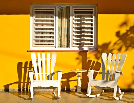 Beautiful Garden African chairs at Cuban Yellow House, White Cuban Chairs,  Resting Chairs at Cuba, Vinales, Background Yellow