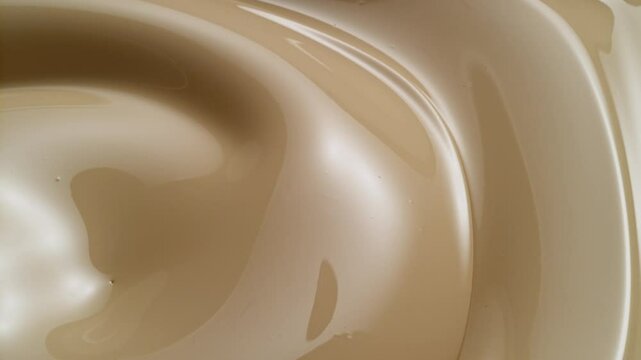 almonds pouring on creamy white chocolate or ice cream mixture