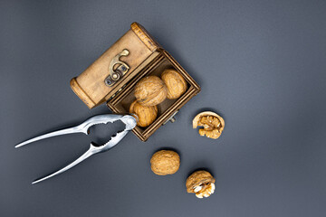 Whole walnuts in a wooden chest, top view.