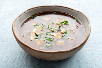 Tofu soup, Japanese cuisine. Miso soup with bean curd and green onions, with buckwheat noodles. Simple minimalist dish recipe