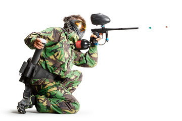 Painball player in action isolated om white bacground