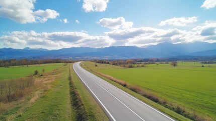 Serene countryside highway with scenic mountain view on a sunny day