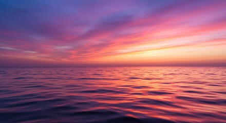 Fototapeta premium Twilight Sea: Witness a breathtaking ocean panorama where the sky is ablaze with hues of pink, purple, and orange during the golden hour.