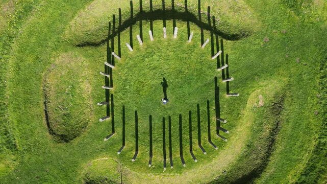 Drone footage of a man standing in the middle of Maelmin Henge near Milfield village, England