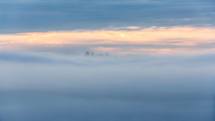 Fototapeta premium Misty landscape with gentle hues and soft light, creating a tranquil and ethereal atmosphere