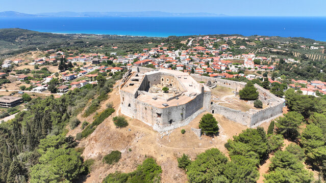 Aerial drone photo of Frankish Castle of Chlemoutsi in area of Kylini overlooking small village of Kastro and deep blue sea, Peloponese, Ilia, Greece