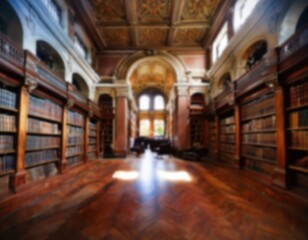 Obraz premium Defocused Beautiful historic library interior with wooden shelves and intricate architecture details