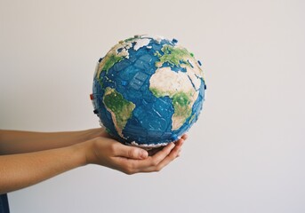 Extended Arm Holding the Earth