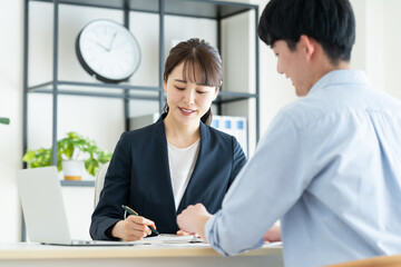 若い男性に提案するビジネスウーマン