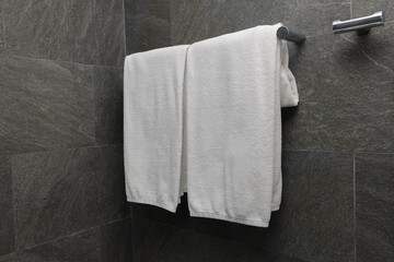 Freshly laundered towels hanging in modern bathroom indoor photography minimalist close-up hygiene