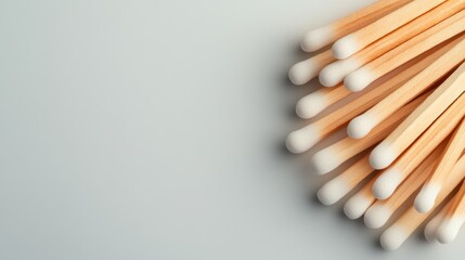 An array of cotton swabs arranged closely, presenting sharp details and textures, illustrating their everyday utility in personal care and hygiene routines.