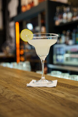 Classic margarita with lime on bar counter