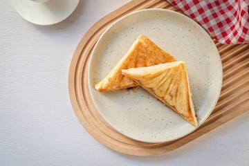 Toasted sandwich in ceramic pĺate on white background, top view with free copy space