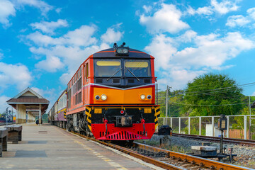Fototapeta premium Diesel locomotive arrives at passenger station passenger carriages day trip