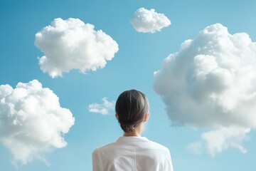 Looking up at fluffy clouds in a clear blue sky while embracing a moment of reflection and tranquility