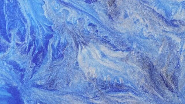 A vibrant composition of swirling blue tones with a glittery texture, creating a dynamic, fluid abstract pattern. Perfect for creative projects, digital art, or as a striking and modern backdrop.