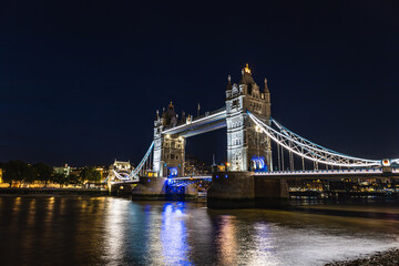Fototapeta premium Tower Bridge Illuminated at Night With Reflections on the River Thames in London